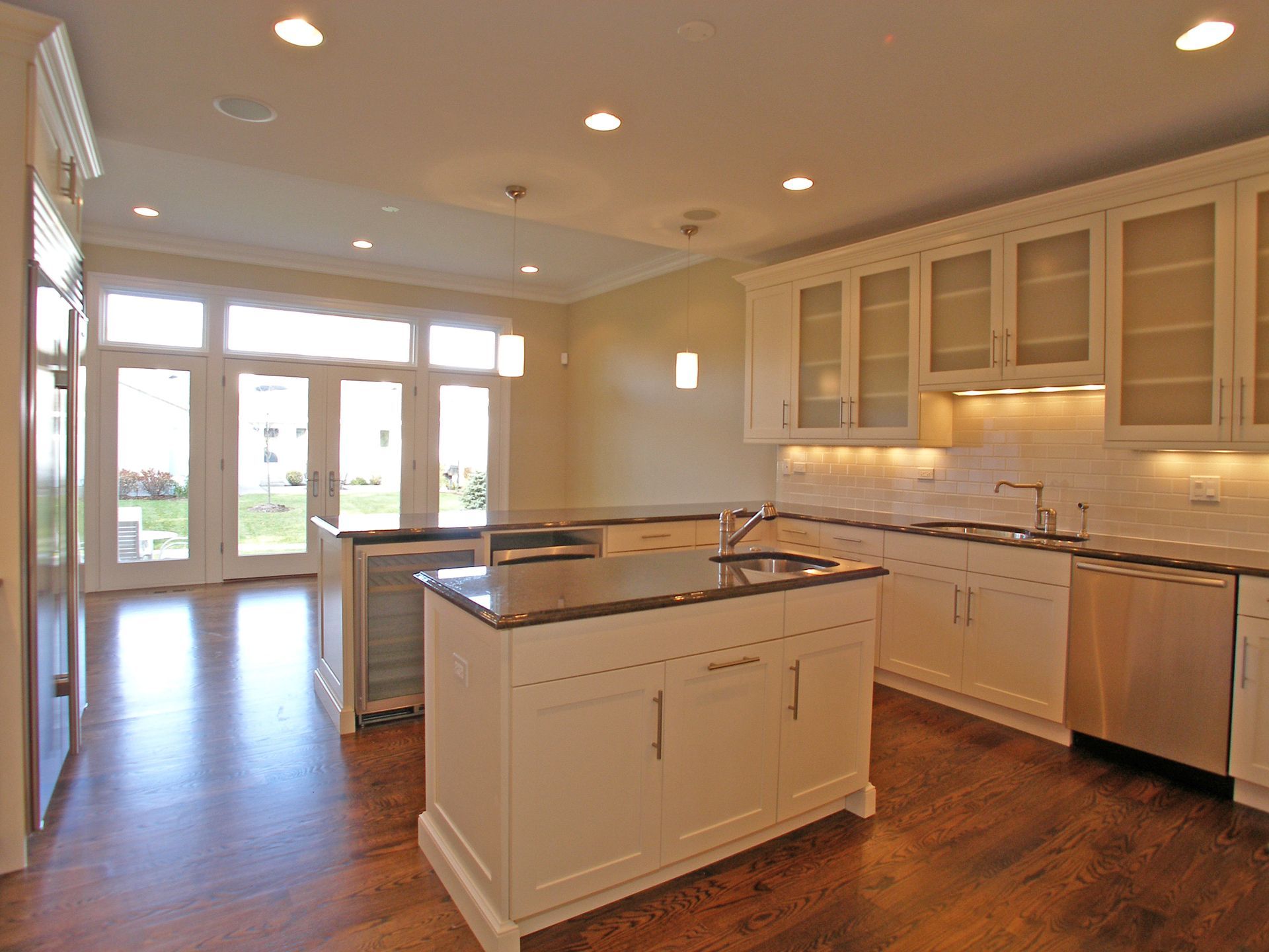 A kitchen with white cabinets and stainless steel appliances
