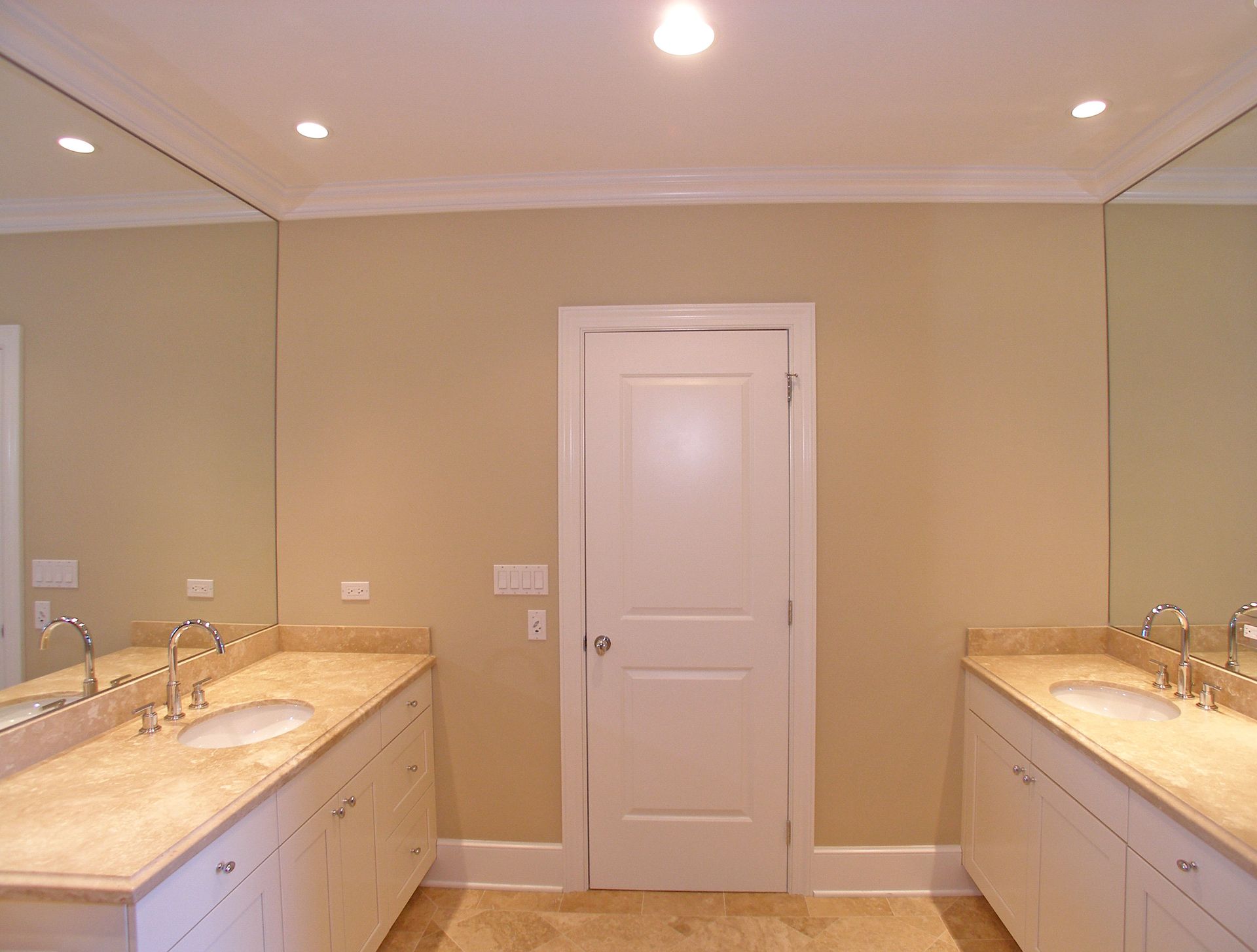 A bathroom with two sinks and two mirrors