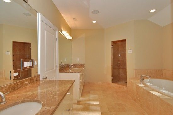 A bathroom with two sinks and a bathtub