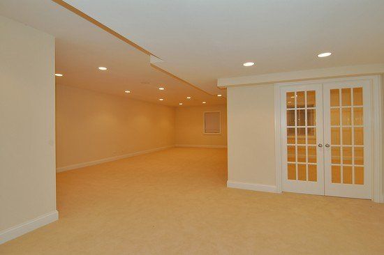 An empty room with a french door in the middle