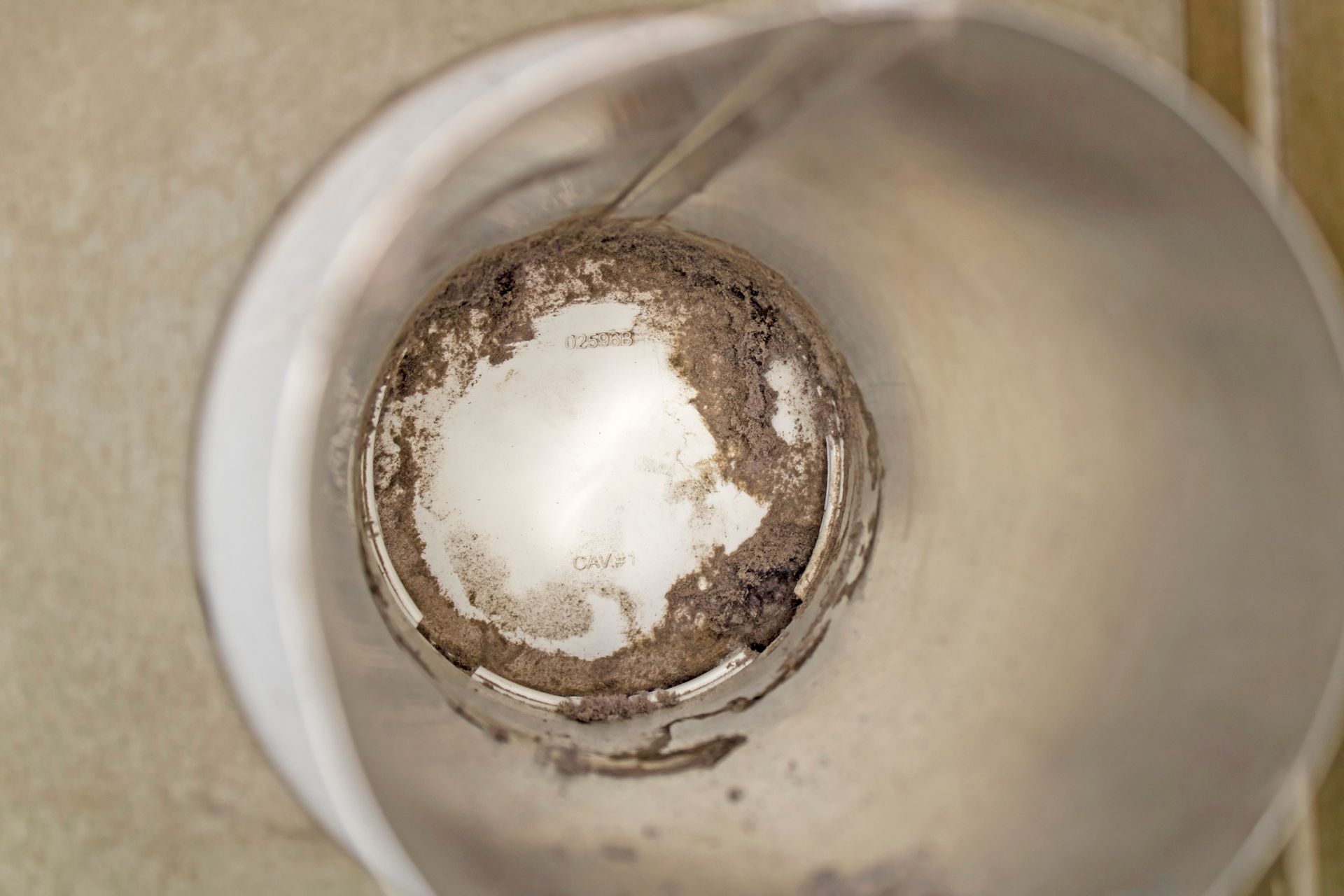 A close up of the inside of a dirty coffee cup.