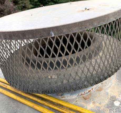 A metal grille is sitting on top of a concrete surface.