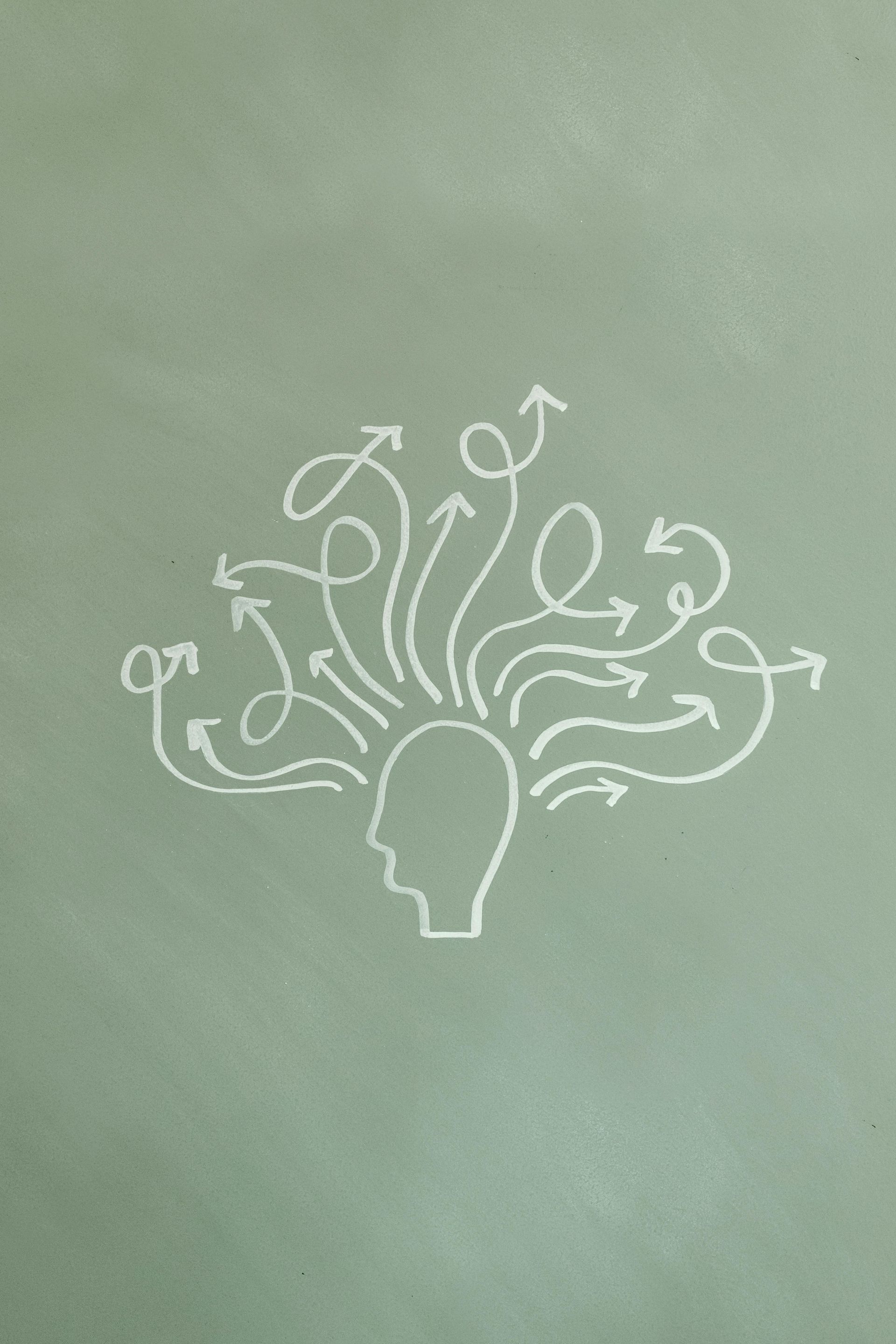 Head silhouette with arrows swirling outward, symbolizing thoughts or ideas on green background.