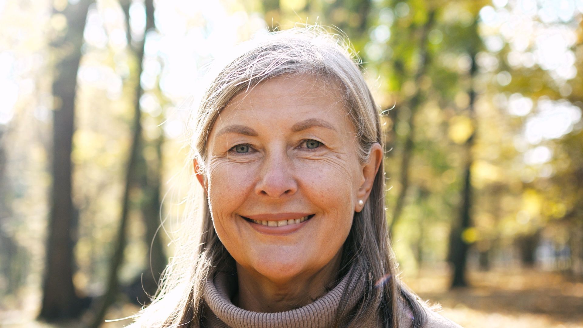 A close up of an older woman smiling.