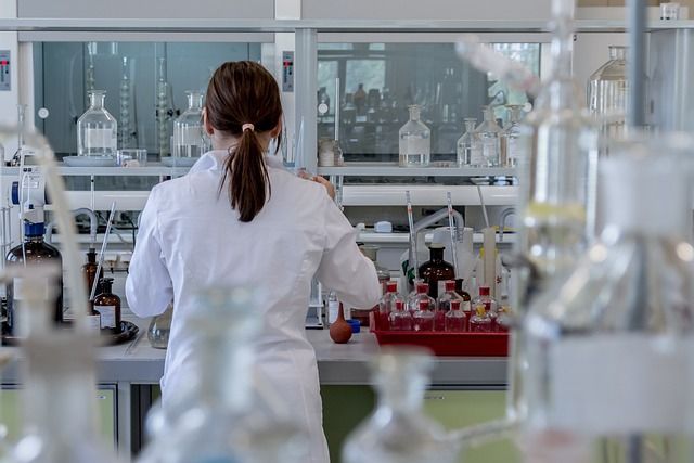 A woman wearing a lab coat while working in a laboratory.