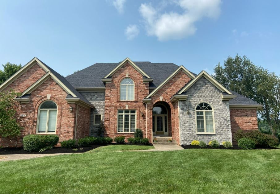 Large Brick And Stone House Lush Green Lawn — Louisville, KY — Titan Landscape Group
