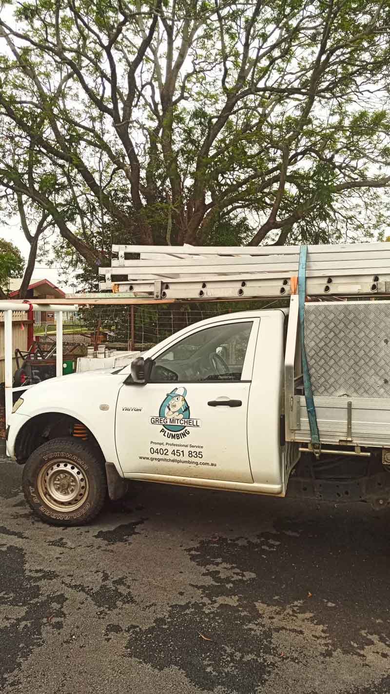 A White Truck With a Ladder on the Back is Parked on the Side — Greg Mitchell Plumbing In Murgon, QLD