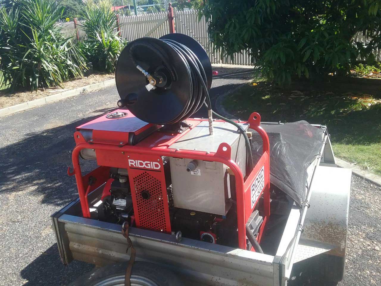 A Red Machine is Sitting on Top of a Trailer — Greg Mitchell Plumbing In Murgon, QLD
