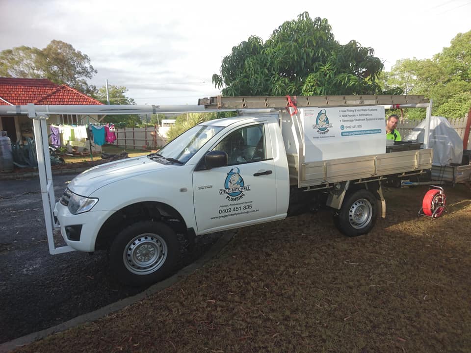 A White Truck is Parked in Front of a House — Greg Mitchell Plumbing In Murgon, QLD