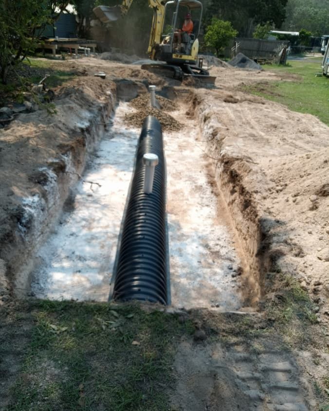 A Large Pipe is Being Installed in a Hole in the Ground — Greg Mitchell Plumbing In Murgon, QLD