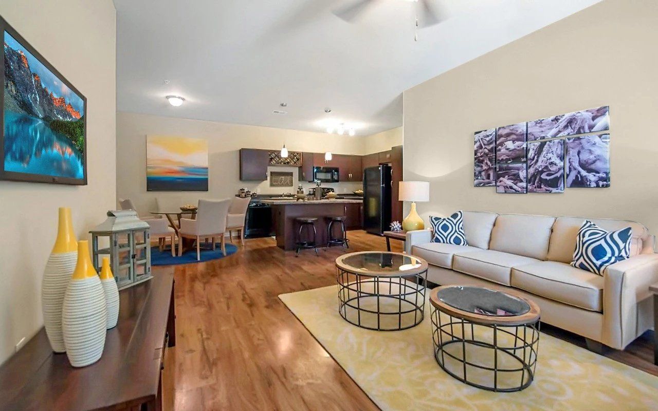 A living room with a couch, two coffee tables, and a television at Preserve at Essex Farms, which offers apartments in Charleston, SC.