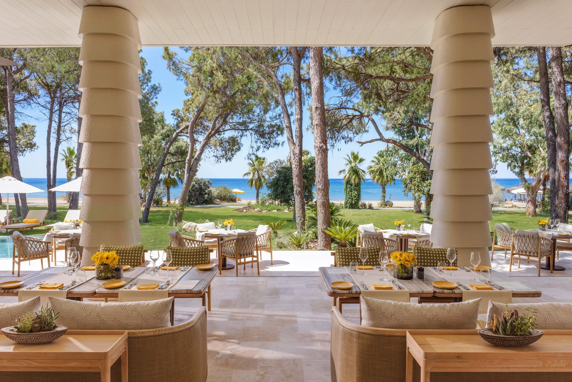 A restaurant with a view of the ocean and trees