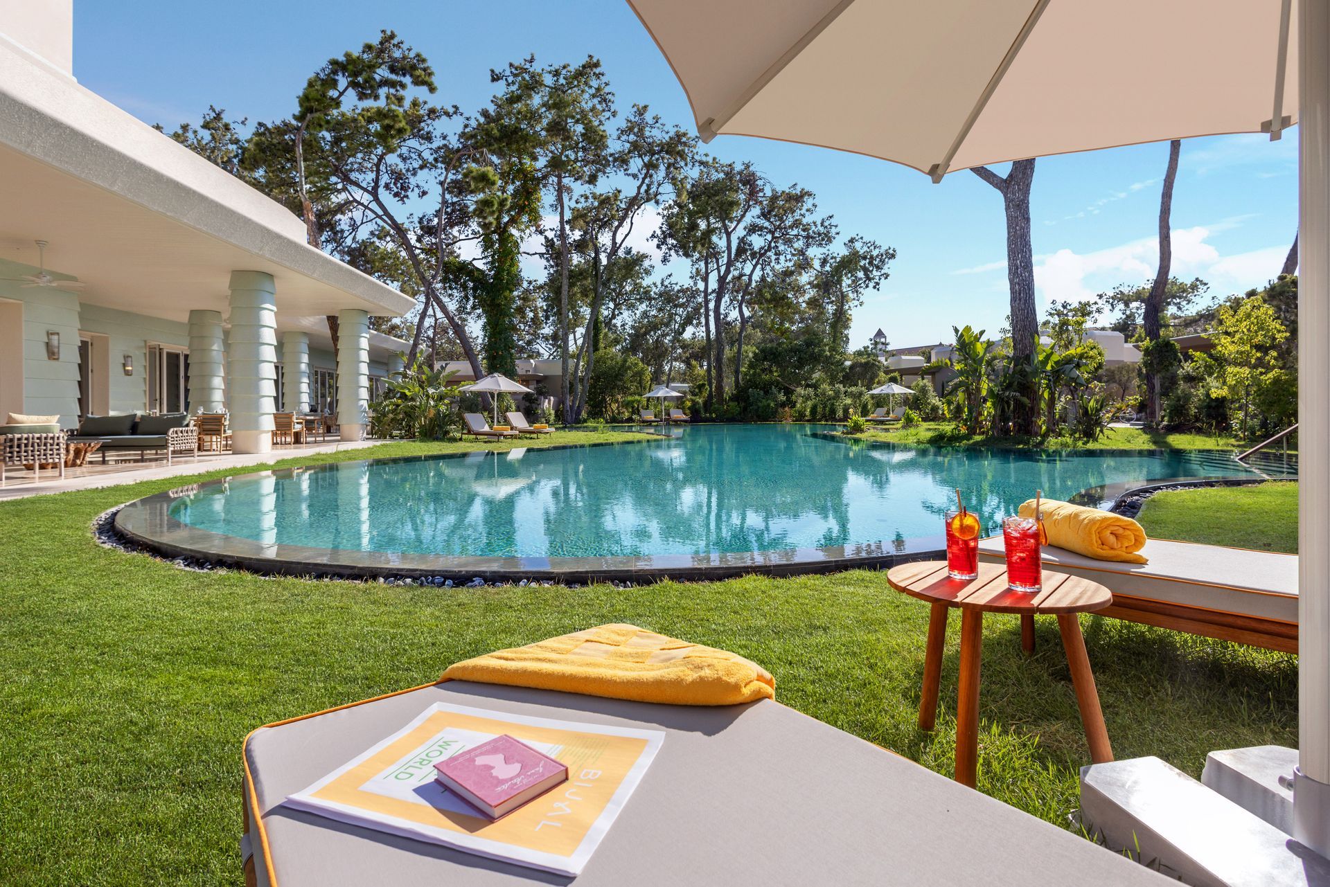 There is a large swimming pool in the backyard of a house.