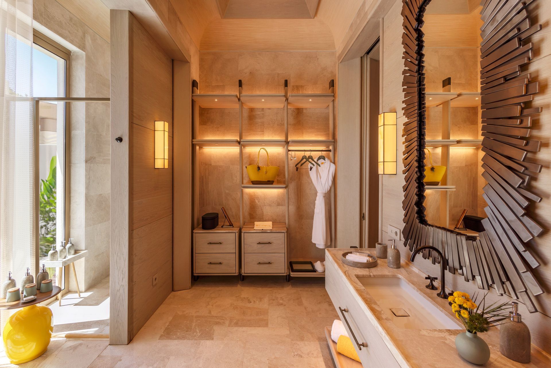 A bathroom with a sink , mirror and walk in closet.