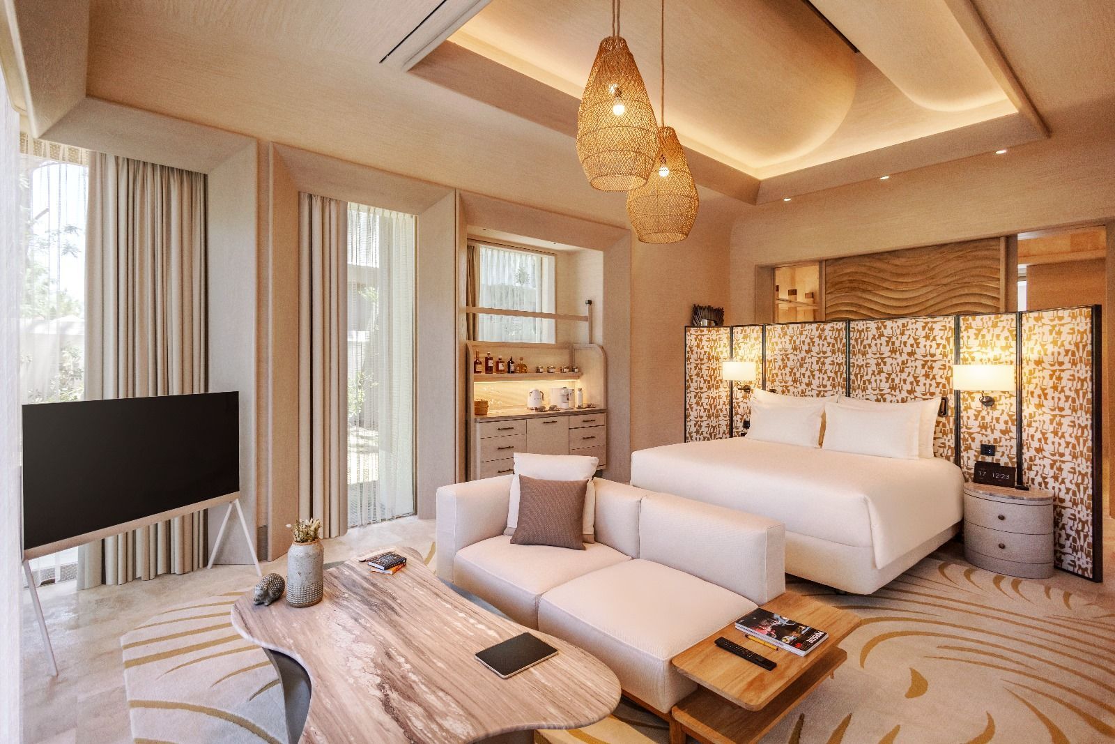 A hotel room with a large bed , couch , and television.