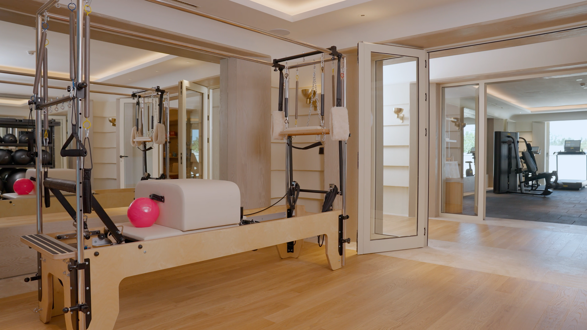 There is a pilates machine in the middle of the room.