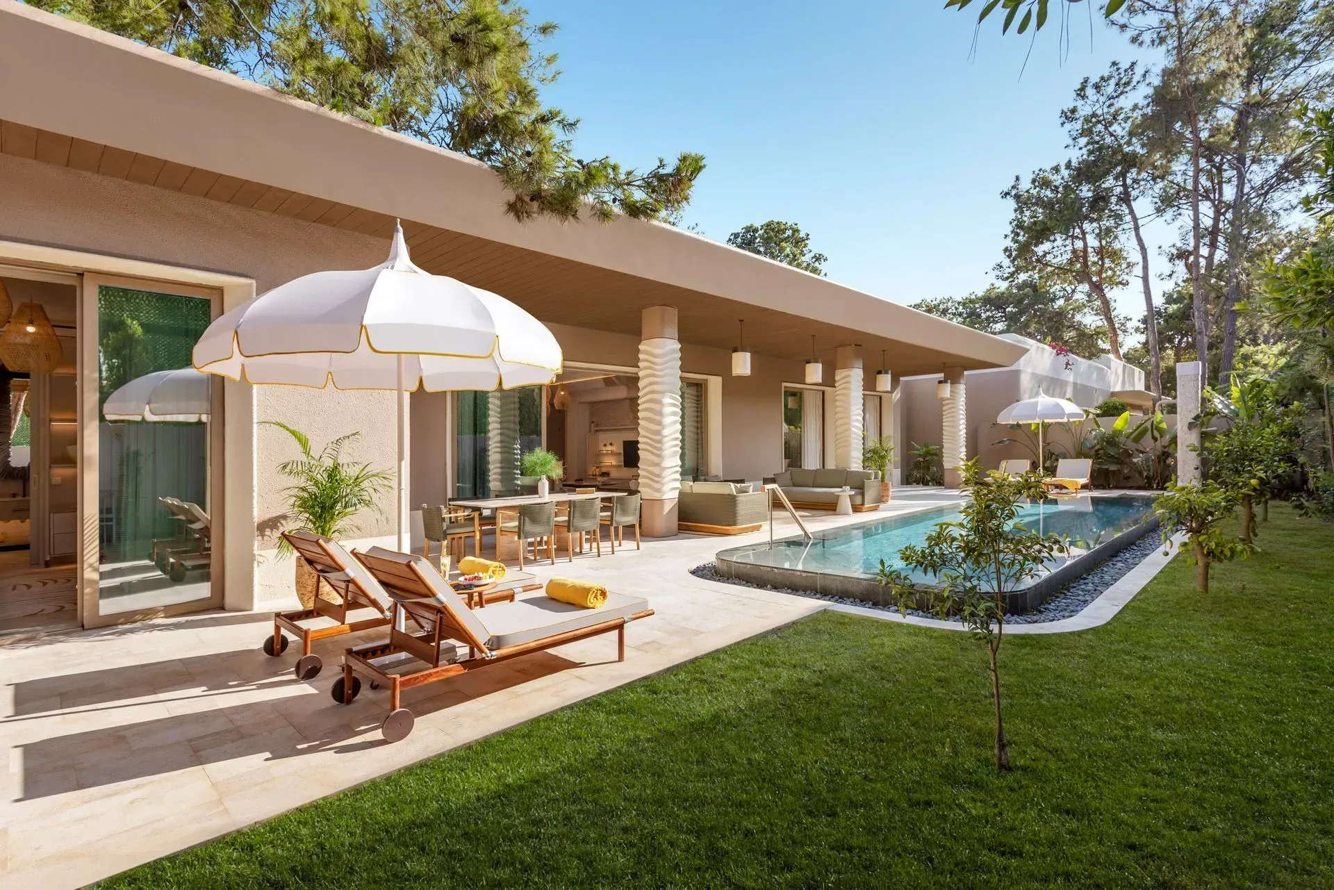 There is a large swimming pool in the backyard of a house.
