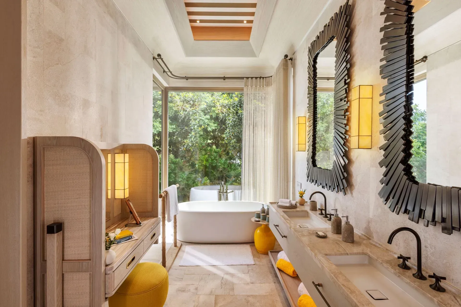 A bathroom with two sinks , a tub and two mirrors.