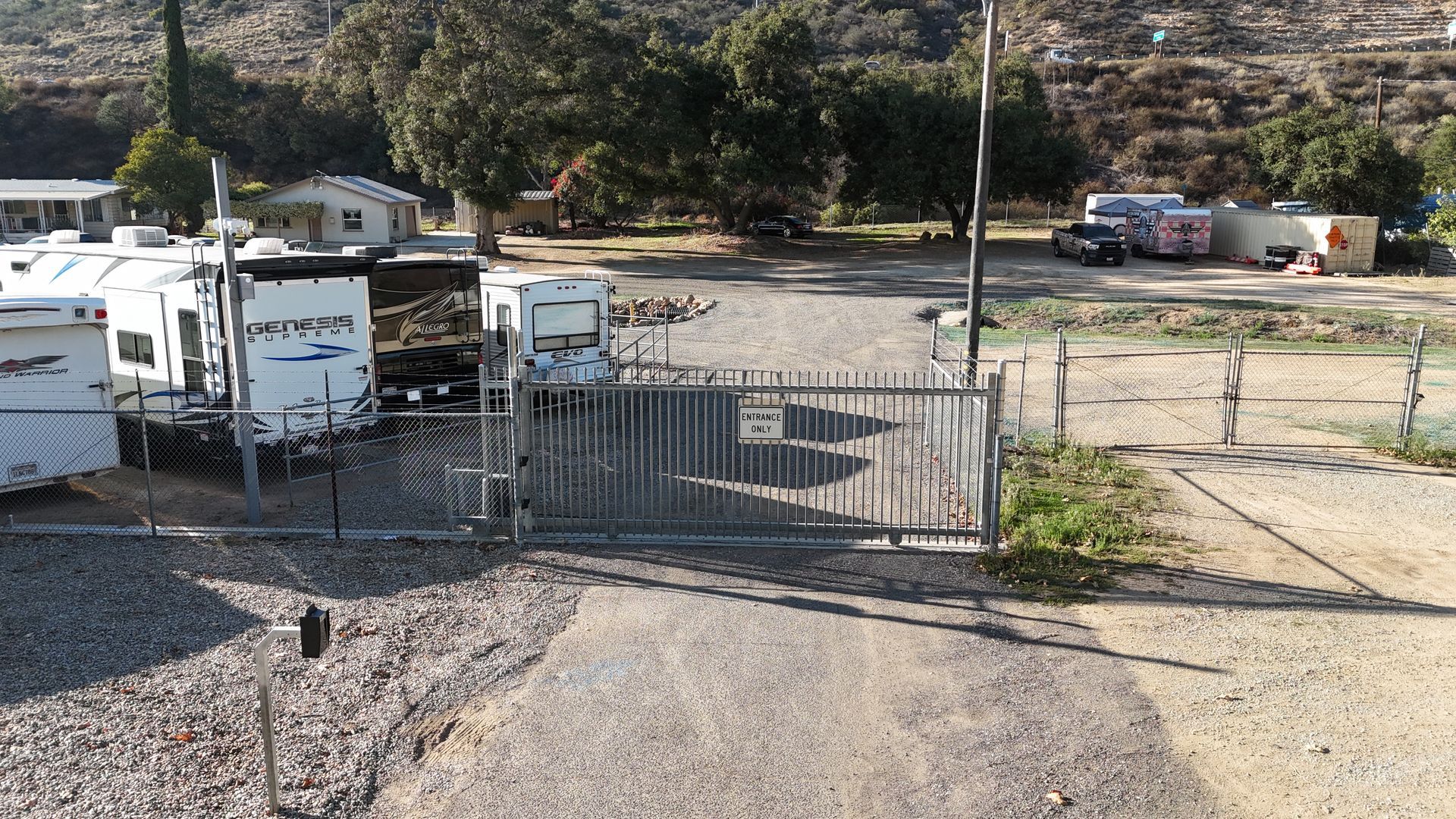 Parking garage entrance with barrier gate and security camera.