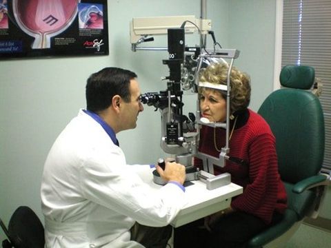 Dr. Kurt J. checking on female patients eyes — Laurinburg, NC — Laser Eye Institute PA