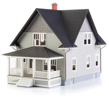 A model house with a black roof and a porch