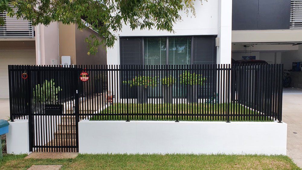 Black Aluminum Fence And Gates In The Front Of The House — Aluminium Gates in Burleigh Head, QLD