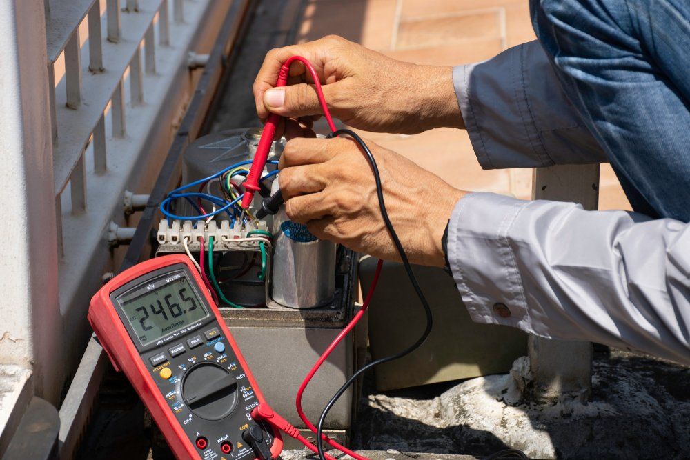 Technician man using digital multimeter  — Gate Repairs in Burleigh Heads, QLD