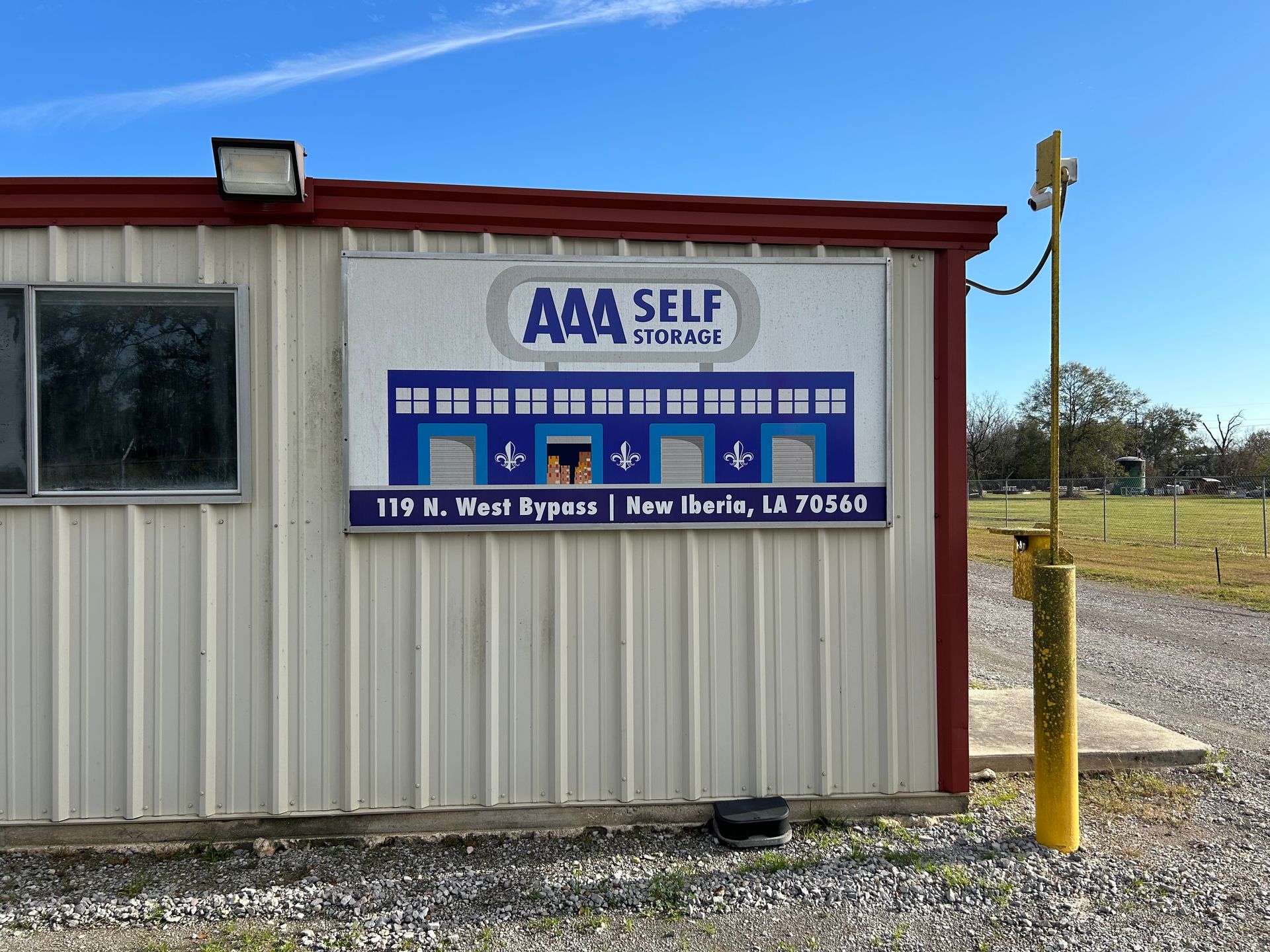 AAA Self Storage building with sign; blue, white, red, and gold; located in New Iberia, LA.