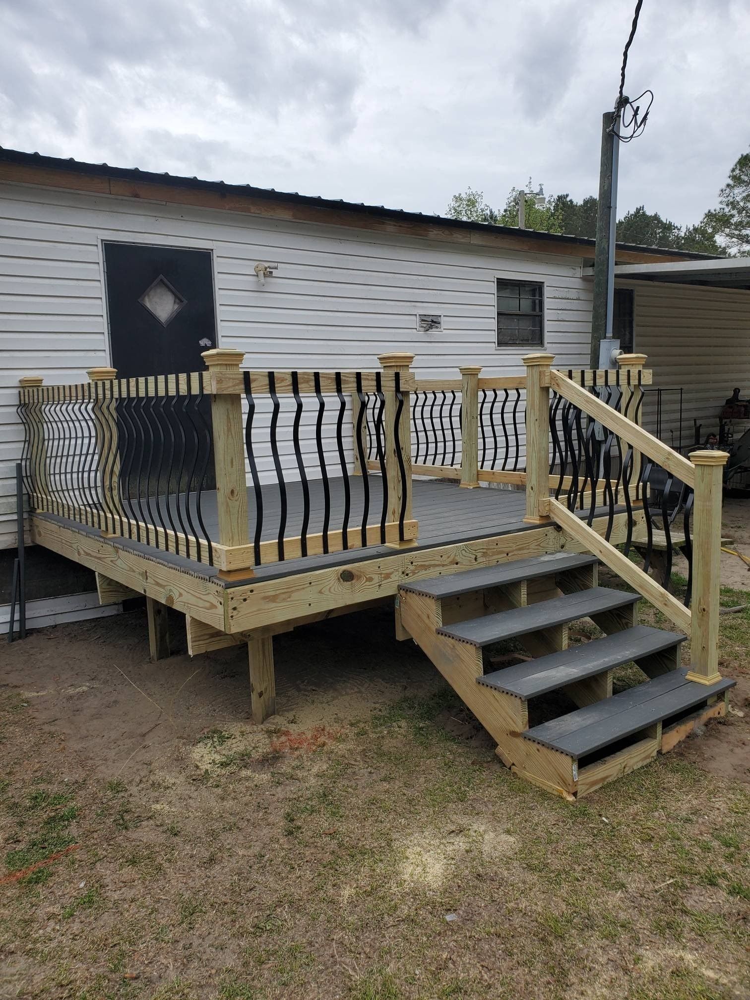 Modern bathroom with brown vanity, white sink, and light wood door.