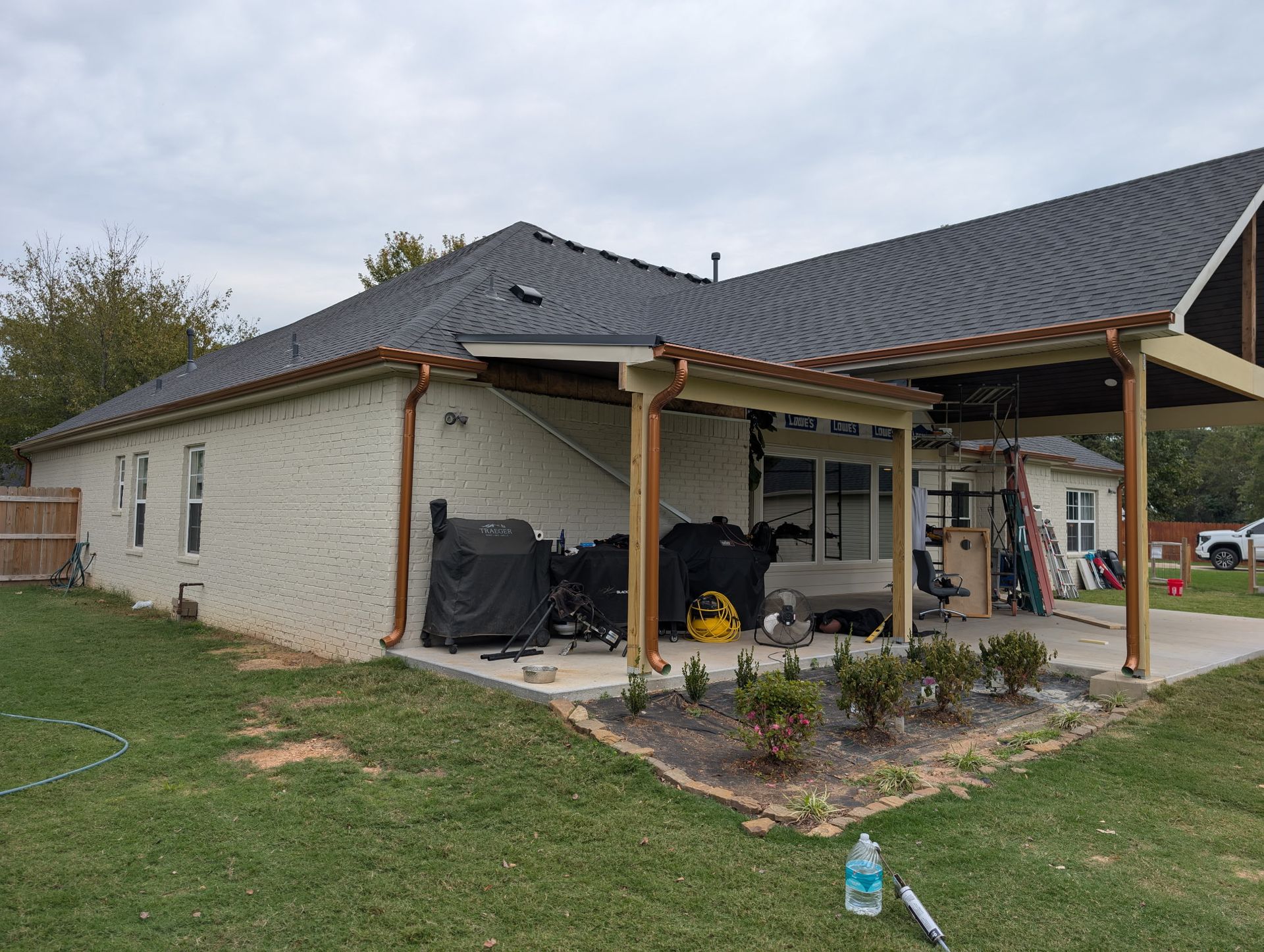 Custom gutters were installed by Hog Trough Seamless Gutters, providing irrigation for a garden bed.