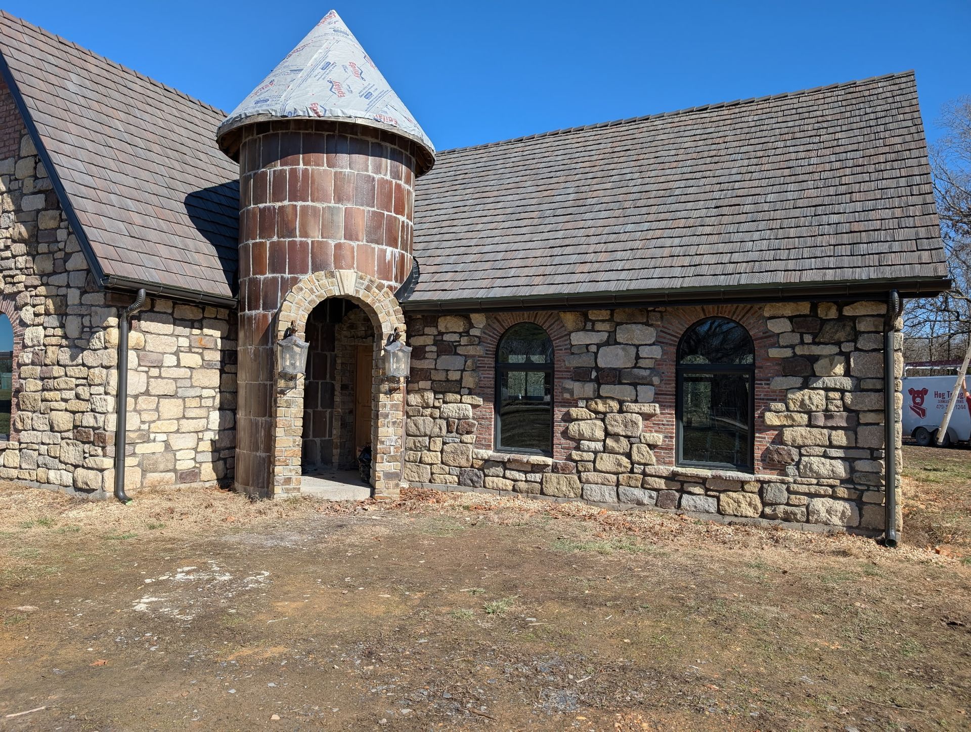 A newly built home resembling a castle: New gutters were installed, custom made by Hog Trough Seamless Gutters