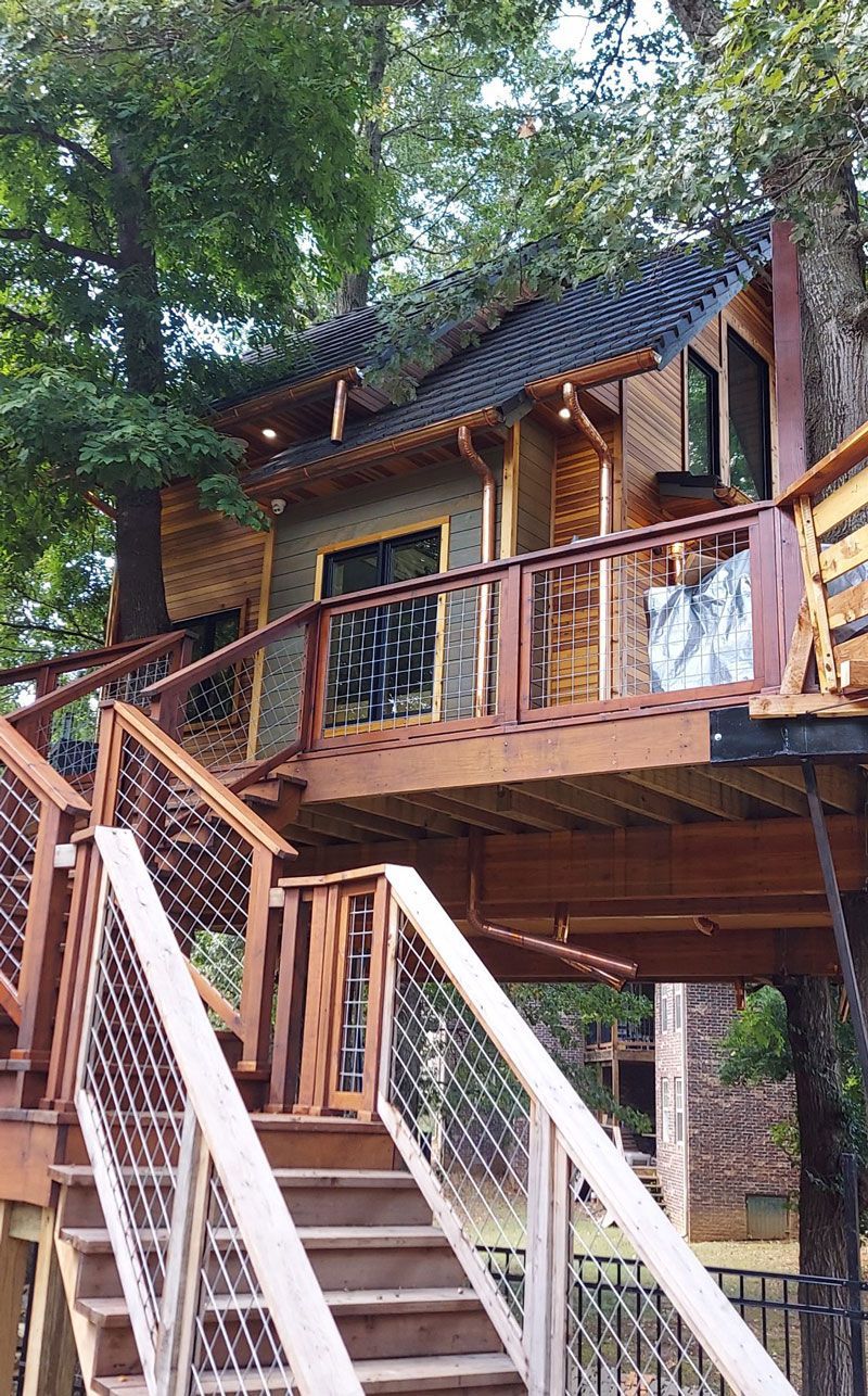 A tree house with stairs leading up to it.