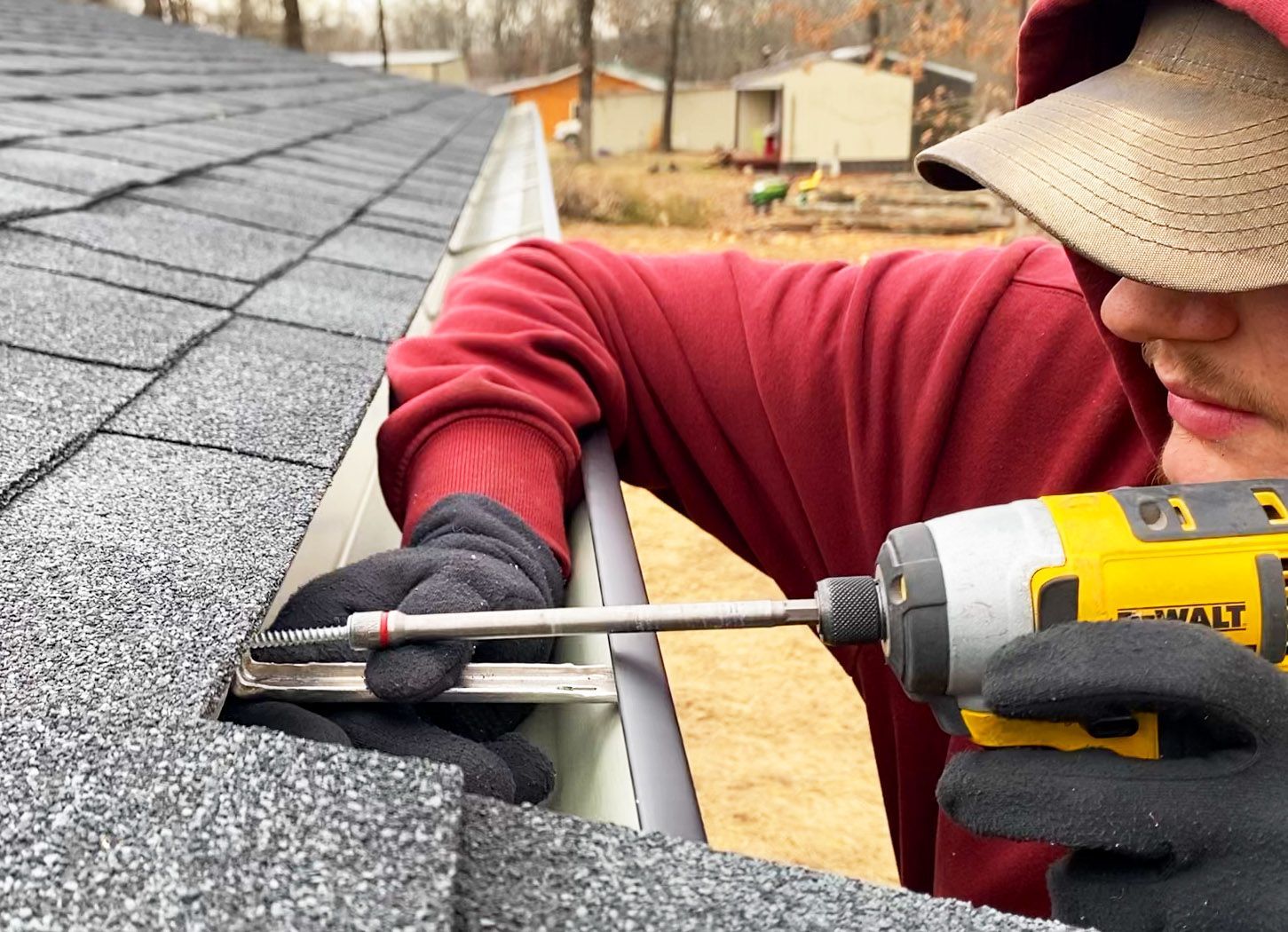Hog Trough employee drilling a gutter 
