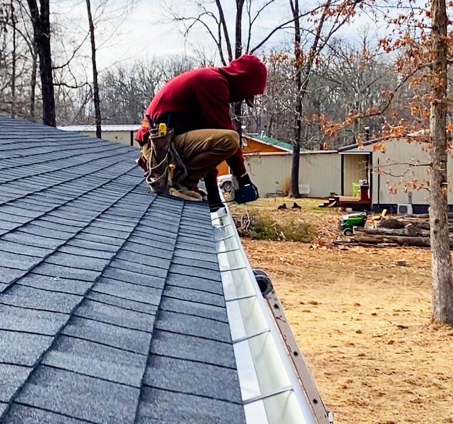 Hog trough employee working on top of a roof 