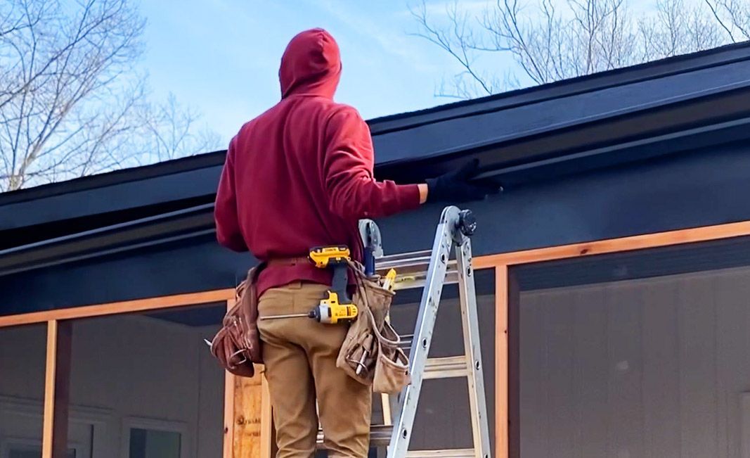 Hog Trough employee working on gutters 