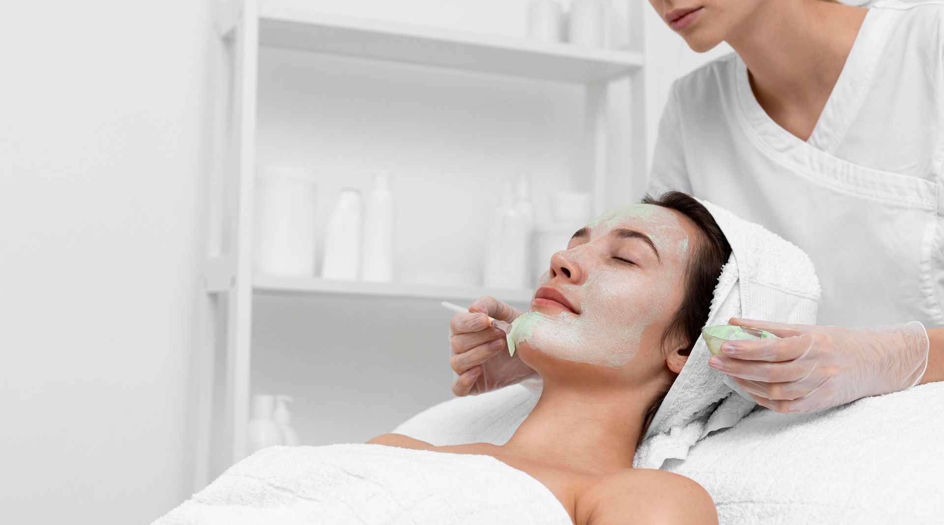 A woman is getting a facial treatment at a spa.