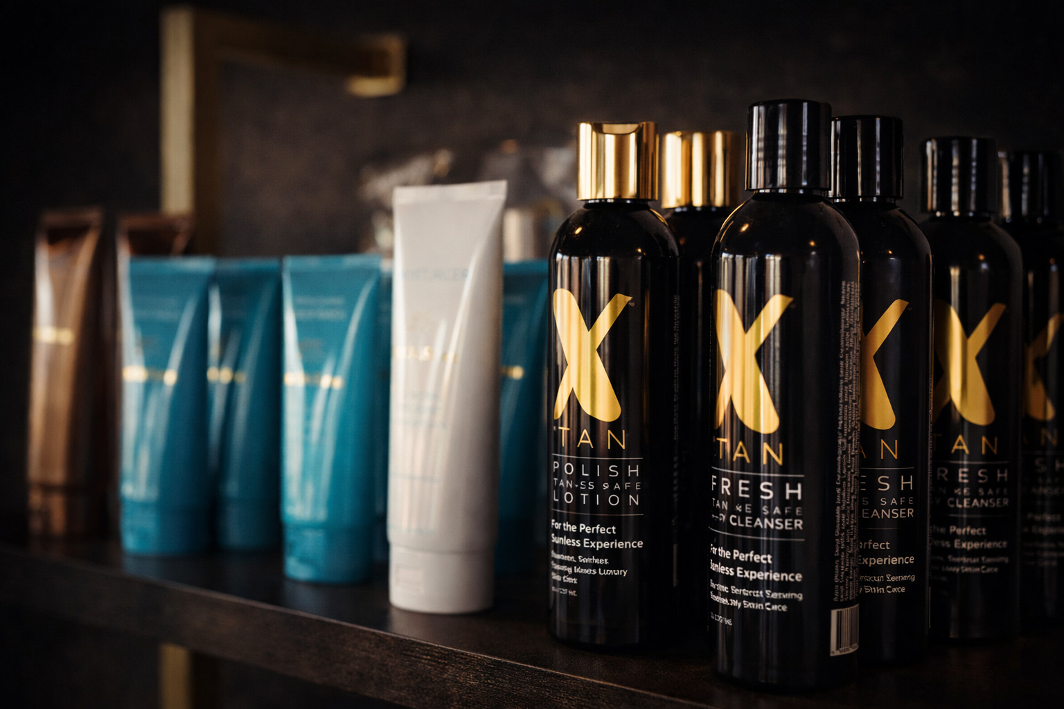 Shelf of tanning lotions and body care products with gold and black branding.