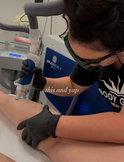 A woman wearing black gloves is using a machine that says this and yap