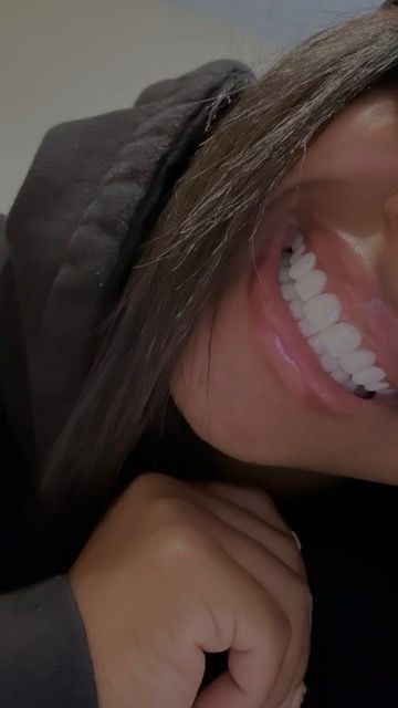 A close up of a woman 's face with a smile on her face.