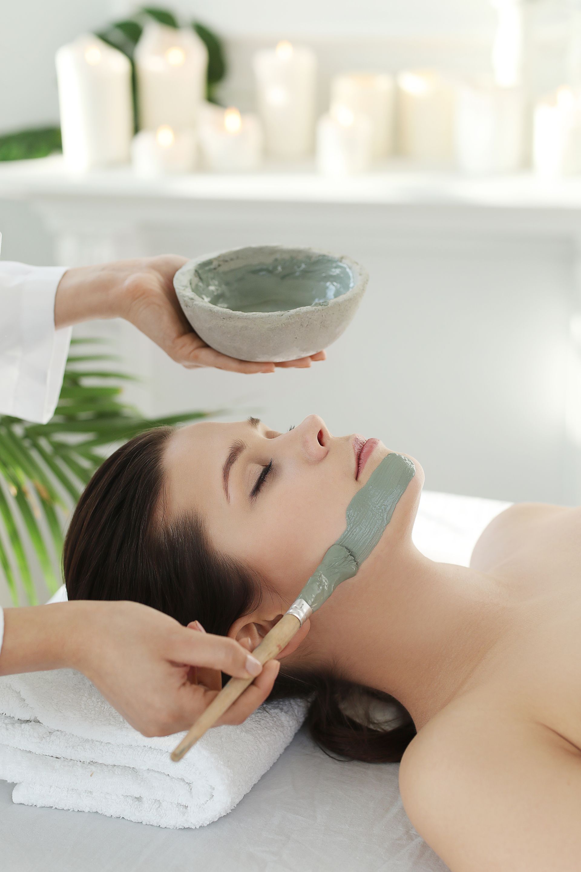 A woman is getting a facial treatment at a spa.