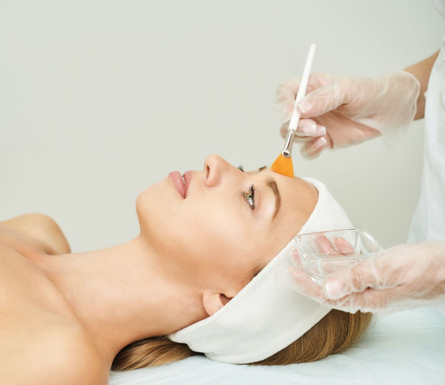 A woman is getting a facial treatment at a spa.