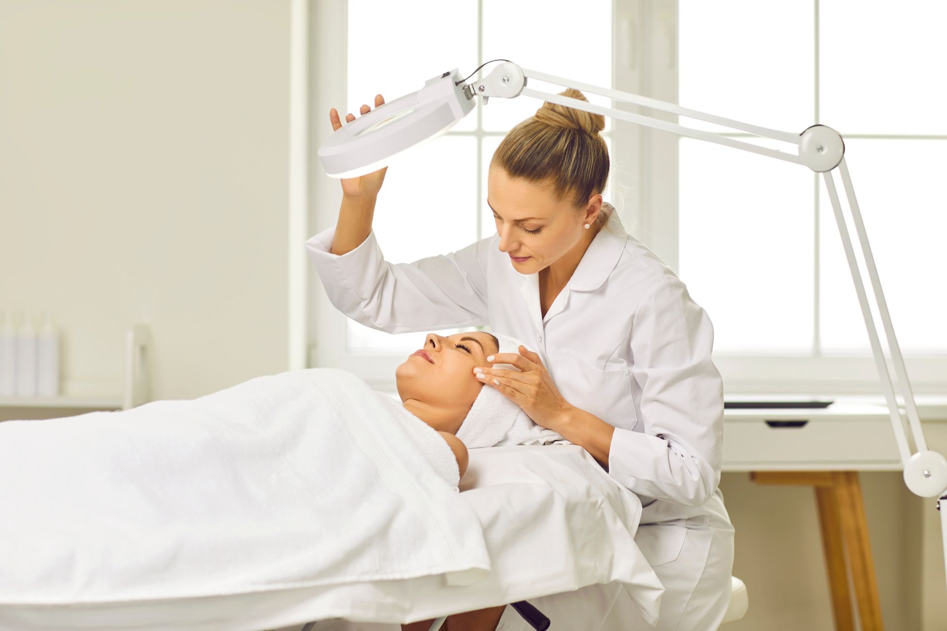 A woman is getting a facial treatment in a beauty salon.