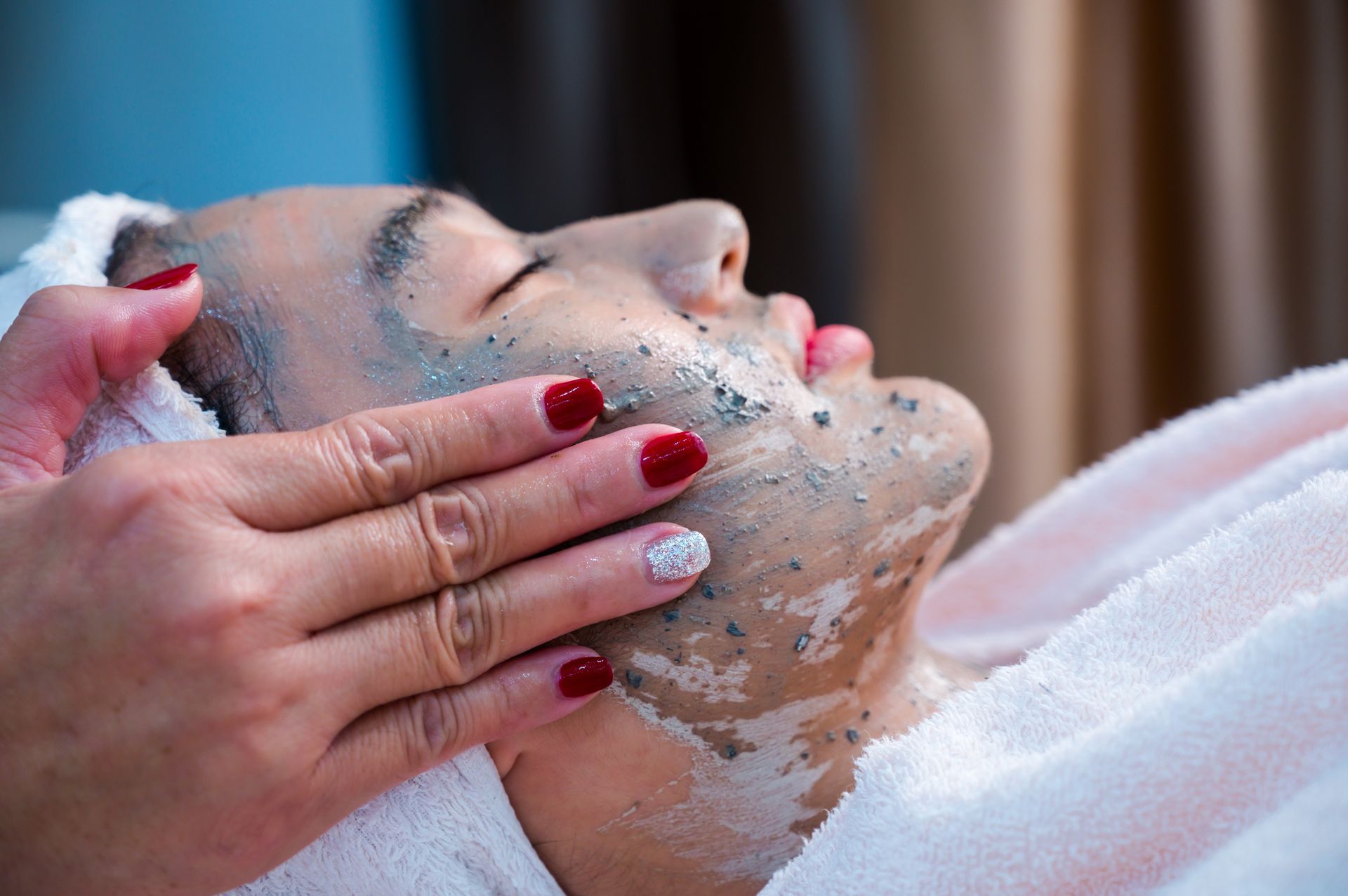 A woman is getting a facial treatment at a spa.