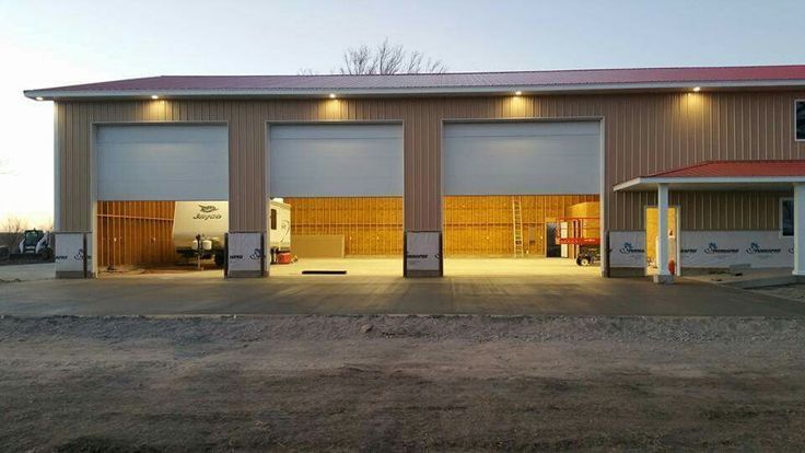 A red and white car is parked in a garage.