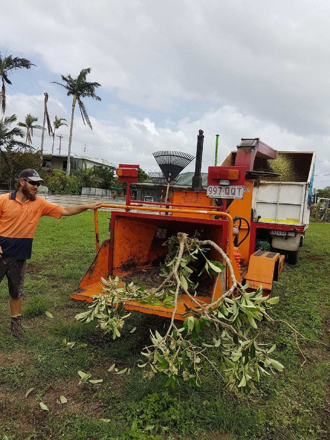 Blue Wood Chipper Processing Wood, Ejecting Chips Into a Container — Airlie Tree Specialists Pty Ltd in Proserpine, QLD