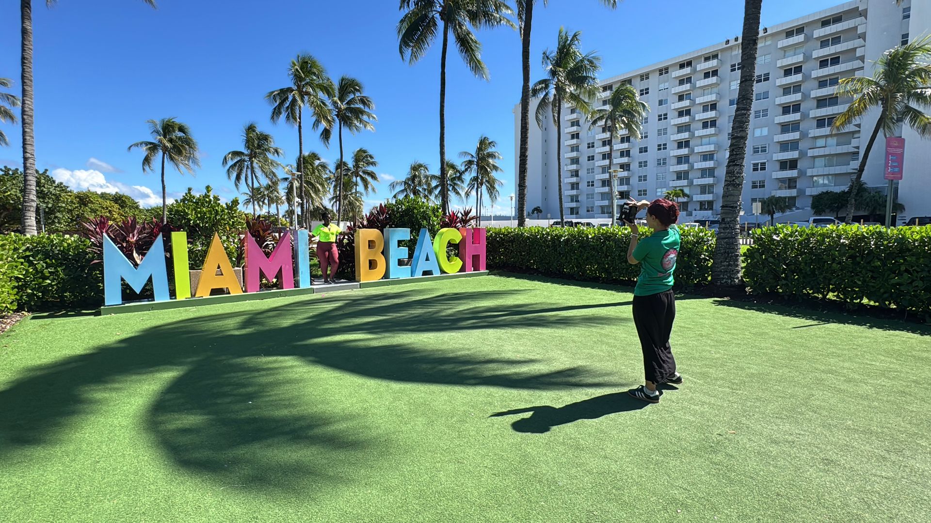Our Miami Architecture Tour guide will take photos of you in front of the colorful Miami Beach sign.