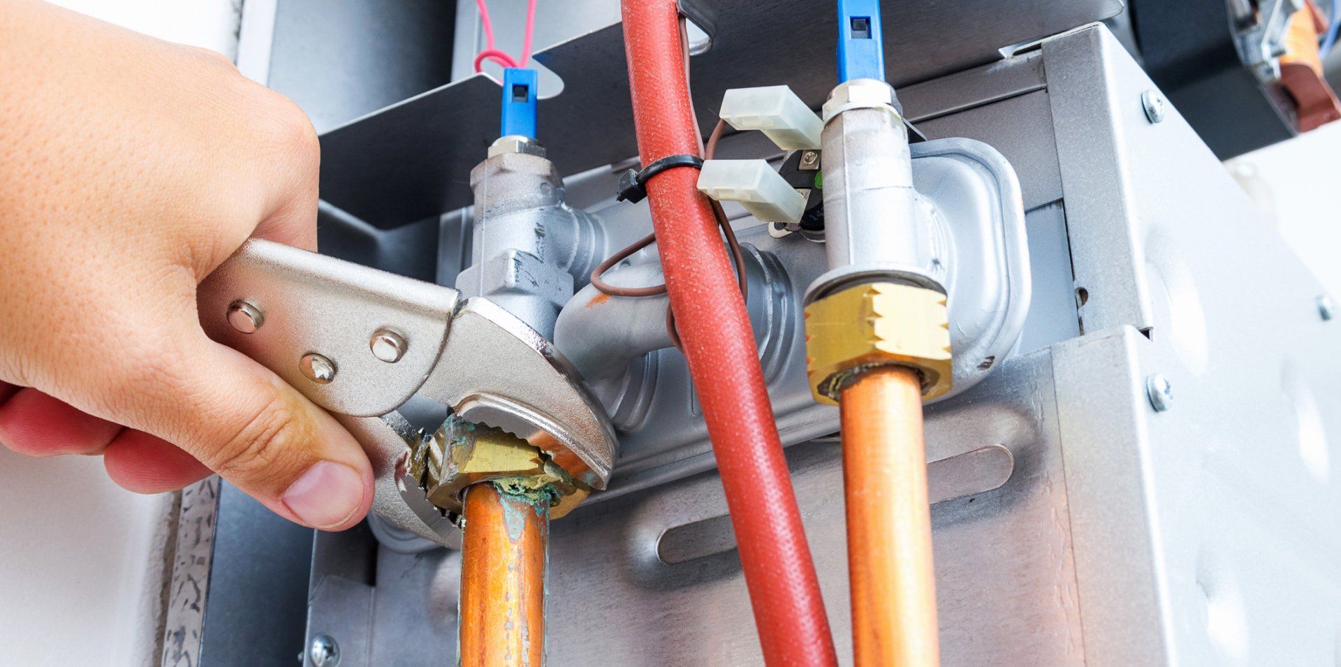 Plumber Repairing A Gas Boiler — Vernal, UT — Airco Heating & Cooling Inc