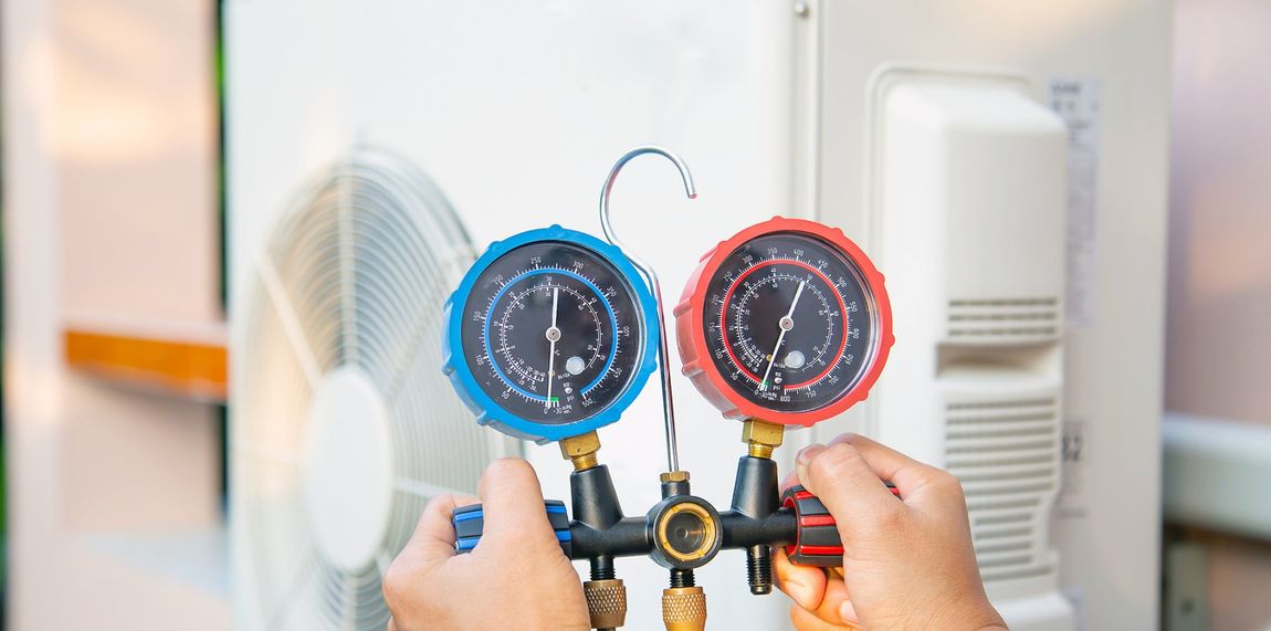 Using A Measuring Tool To Check Air Conditioner — Vernal, UT — Airco Heating & Cooling Inc
