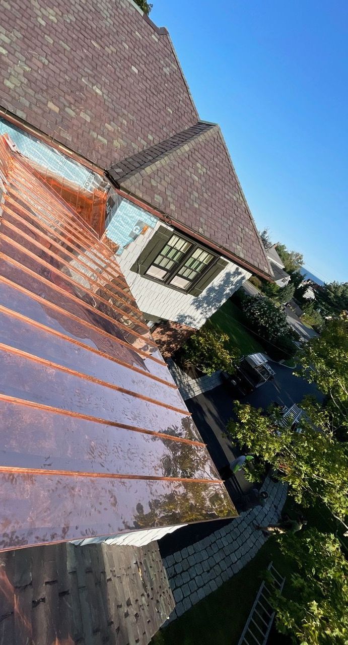 An aerial view of a house with a copper roof.