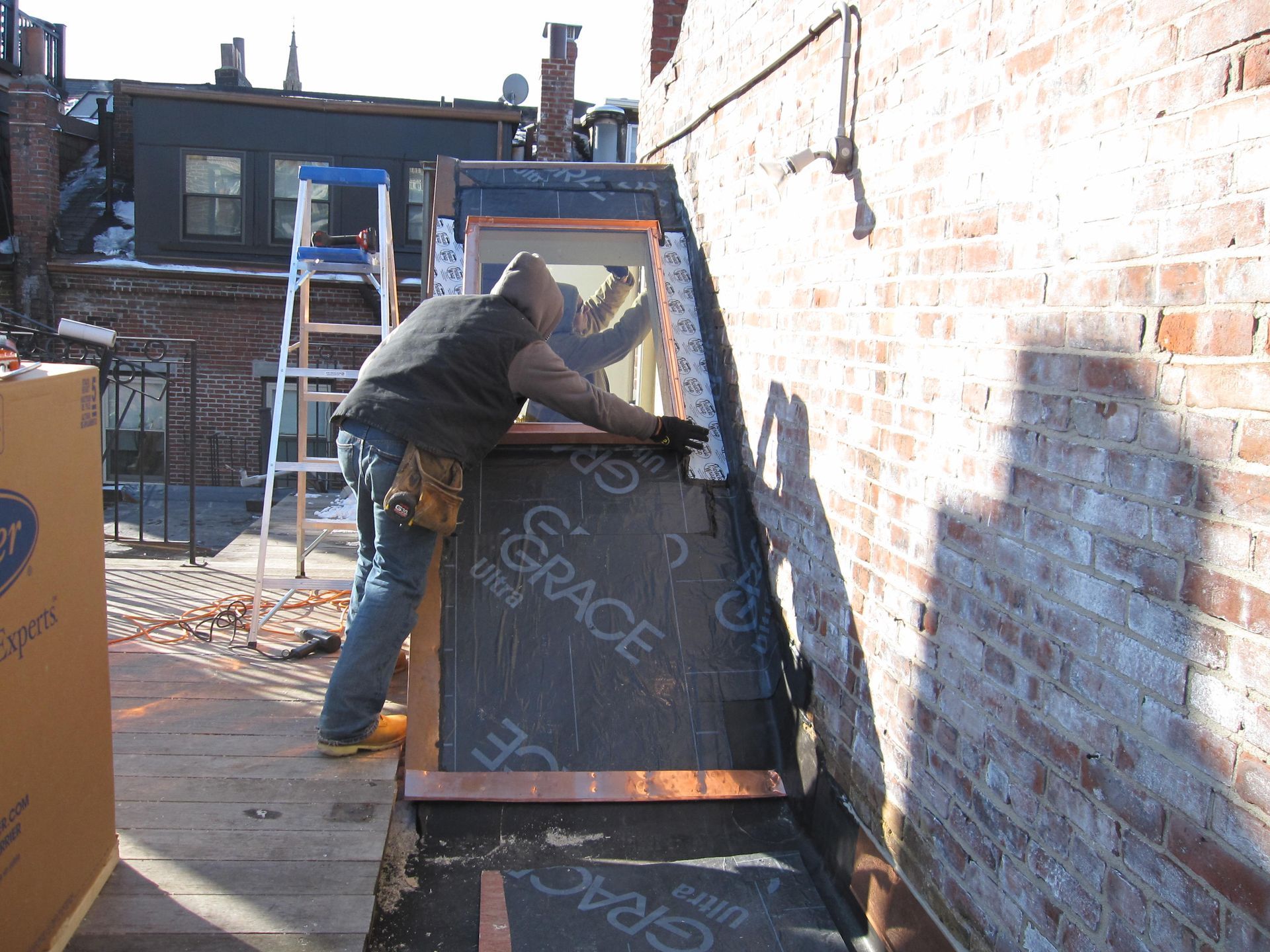 A man is working on a brick wall with a piece of paper that says grace on it